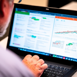 A business analyst reviewing an auto-generated report on a laptop.