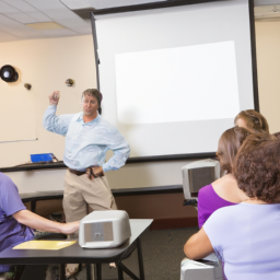 A classroom setting with an instructor using a projector to teach a small group.