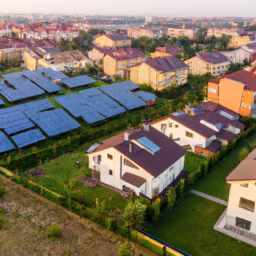 A drone shot of a sustainable residential neighborhood with solar panels on rooftops.