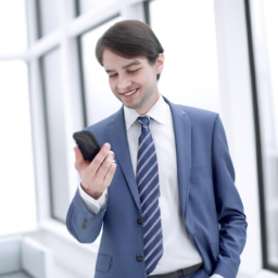A happy employee looking at their predictable work schedule on a smartphone.