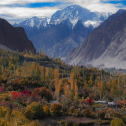 A panoramic view of the serene Hunza Valley during autumn, with vibrant foliage and snow-capped peaks.