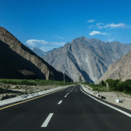 A scenic view of the Karakoram Highway winding through the mountains.