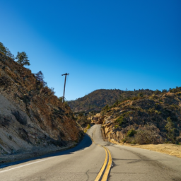 A scenic view of the Karakoram Highway with snow-capped mountains in the background.